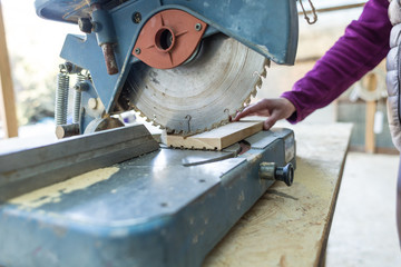 A woman works in a carpentry workshop.