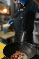 Making dinner at restaurant. Proffesional cooker