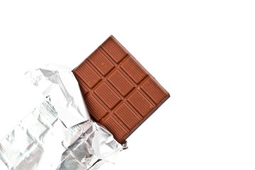Chocolate bar in foil isolated on white background.