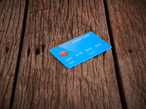 Credit card on old brown wood