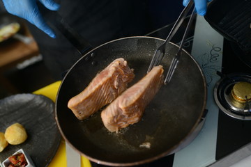 Making dinner at restaurant. Proffesional cooker