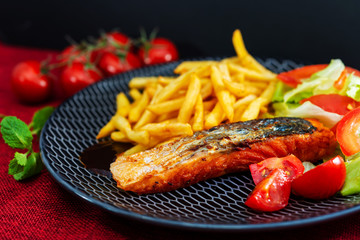 grilled salmon with sauce lemon and tomato