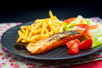 grilled salmon with sauce lemon and tomato