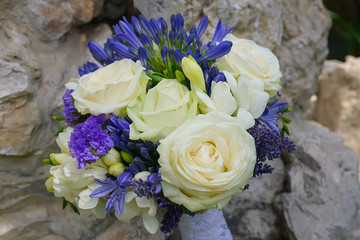 Vibrant, bold bridal round bouquet with ivory roses, fresh lavender, freesias and crocus and...