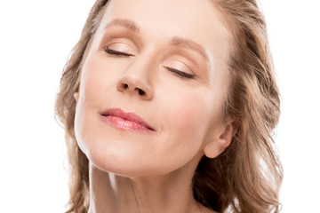 Naklejka premium beautiful middle aged woman with clean face and eyes closed Isolated On White