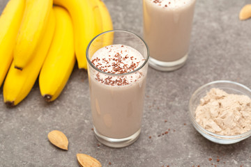 Healthy chocolate banana protein shake with almond milk in a glass. 