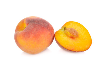 whole and half cut ripe peach on white background