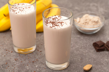 Healthy chocolate banana protein shake with almond milk in a glass. 