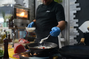 Making dinner at restaurant. Proffesional cooker