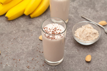 Healthy chocolate banana protein shake with almond milk in a glass. 