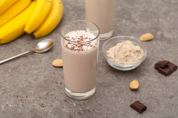 Healthy chocolate banana protein shake with almond milk in a glass. 