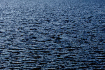 Light playing on the sea surface. Water surface. Sea surface. Water background. Blue water surface 