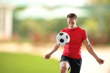 Obraz premium Handsome athletic man with towel on neck in gym