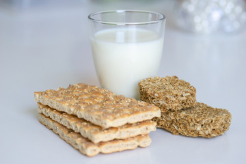 Fototapeta na wymiar The concept of health, diet, proper nutrition. Healthy wheat crackers, crispbreads, grain crackers,milk.