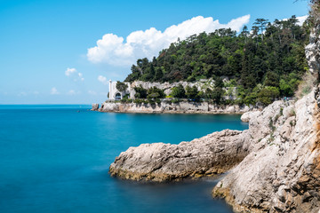 Beautiful sunny rocky beach in Miramare's park, Trieste Italy