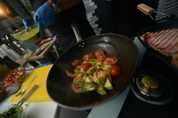 Making dinner at restaurant. Proffesional cooker