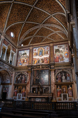 Italy, 03/28/2019: San Maurizio al Monastero Maggiore, 1518 church known as the Sistine Chapel of Milan, details of altarpiece and dividing wall in the faithful's area with frescoes by Aurelio Luini