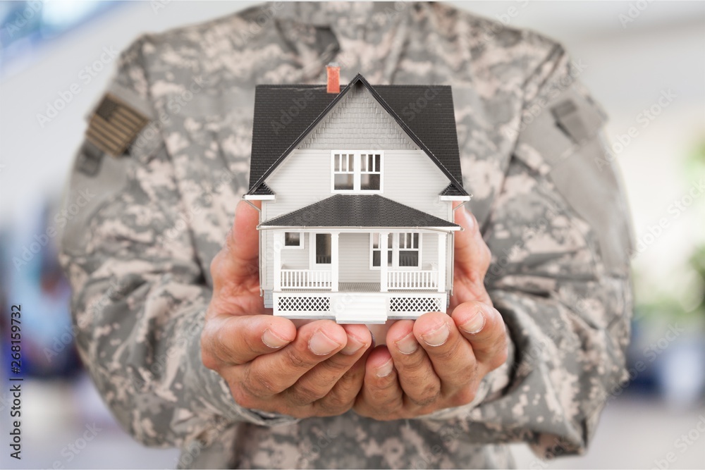 Poster Soldier Holding a Model of House