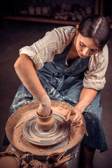 Stylish female master demonstrates the process of making ceramic dishes using the old technology. Making ceramic dishes.