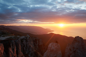 Beautiful sunrise in the mountains. Top of Ai Petri mountain sunset view. Crimea, Russia. vertical
