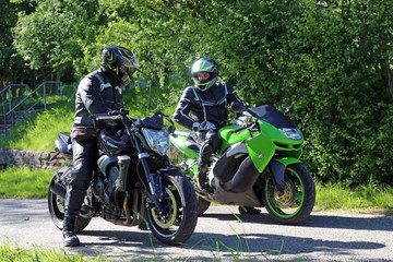 Fototapeta na wymiar Two motorcyclists with a short interstop