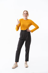 Full length of a smiling attractive young blonde woman