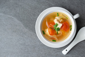 Hot soup chicken healthy at morning on concrete table.