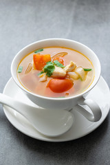 Hot soup chicken healthy at morning on concrete table.
