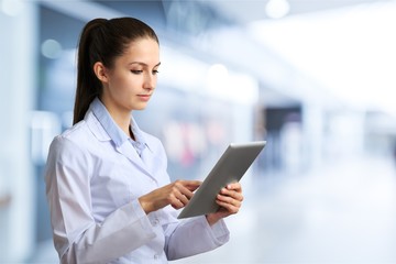 Obraz premium Male doctor with stethoscope on blurred hospital background