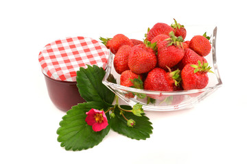 Glass jar of strawberry jam and fresh berries, isolated on white background. Preserved fruits.
