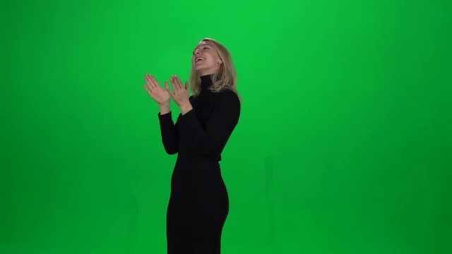 Young female claps. Green screen