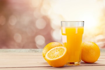 Orange juice and slices of orange on background