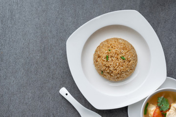 Garlic fried rice and hot soup chicken healthy at morning on concrete table.