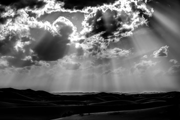 Sand dunes and dramatic clouds in the Sahara Desert in MOrocco