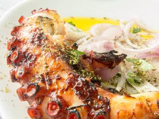 delicious fried octopus tentacle with olive oil and onion