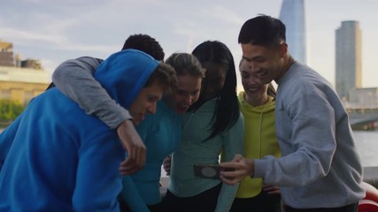 Group of diverse sporty friends take a photo together out in the city 