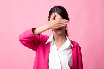 Young Asian woman close her eyes with hand.