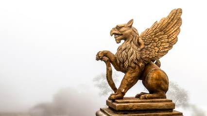 statue of Griffin or griffon a legendary creature with the body of a lion, the head and wings of an...
