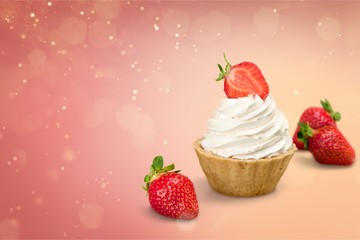 Cupcake with whipped cream and cherry isolated on background