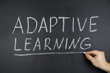 Hand writing topic of Adaptive Learning on black chalkboard