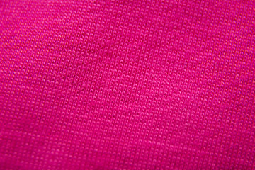Light pink background from a textile material with wicker pattern, closeup. Structure of the rose fabric with texture.