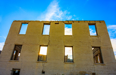 Fototapeta na wymiar Ghost town abandoned building over blue sky