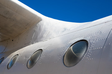 Fuselage cabin. Part of the aircraft. The body of the aircraft against the blue sky.