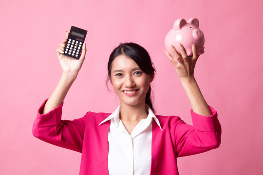 Asian woman with calculator and piggy bank.