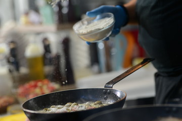 Making dinner at restaurant. Proffesional cooker