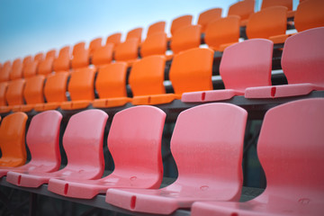 Fototapeta premium Empty colored chairs at the stadium