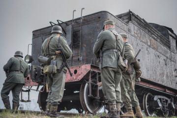  Nazis stand on the background of the train