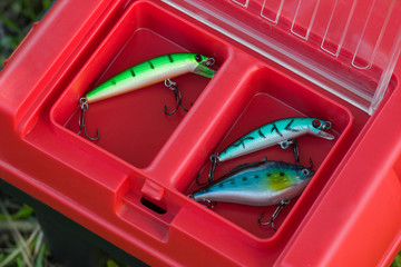 Fishing lures and baits in red tackle box
