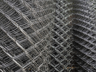 Sale of fencing, rolled into rolls. Galvanized steel grating in stock. Fence with large cells
