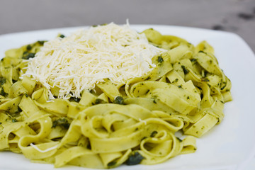 Typical peruvian noodles with basil, spinach and cheese.